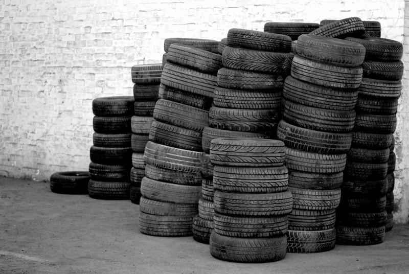 Stacks of used tyres against a wall